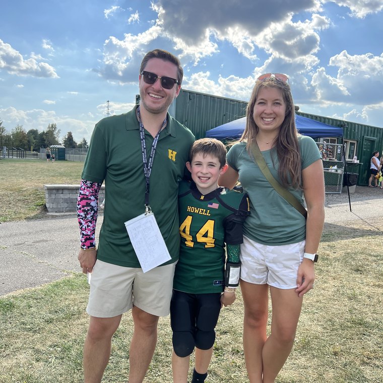 Kyle Evans with family at a youth football game.